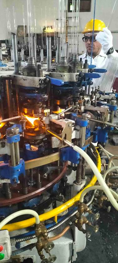 Quality control staff monitoring the ampoule forming line